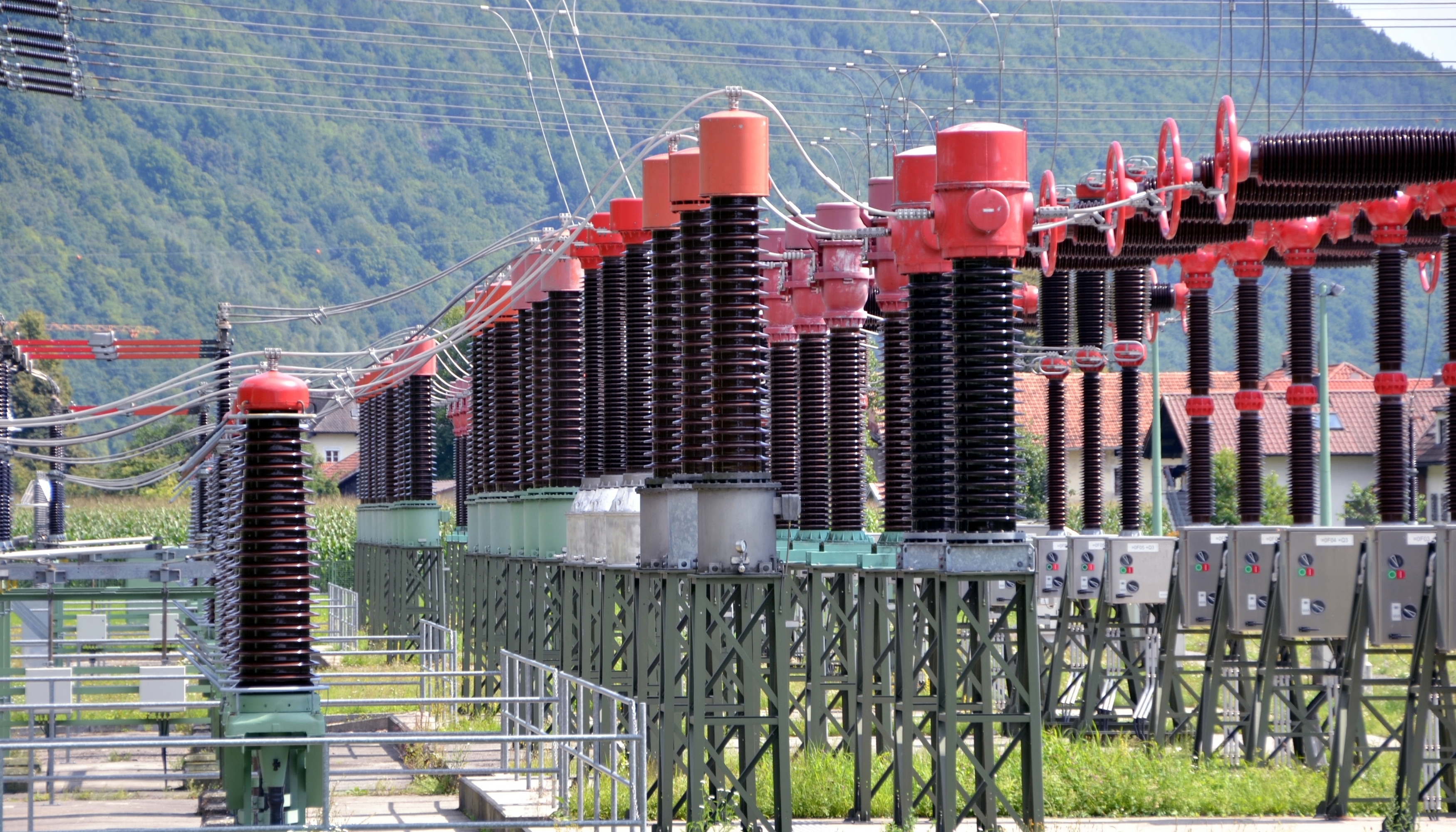 Photorealistic close-up of high-voltage grid equipment and electrical insulators.